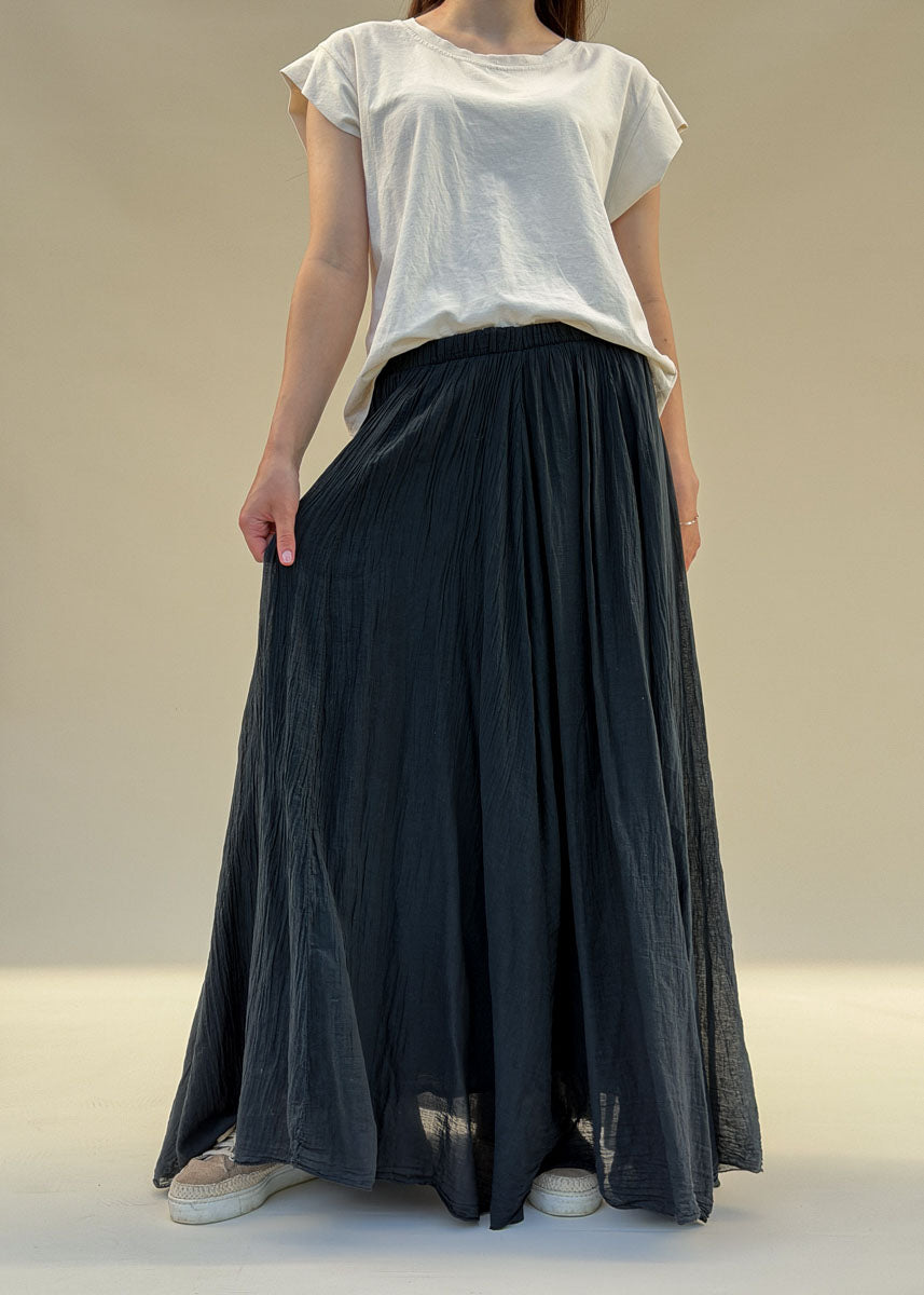 Jupe longue évasée femme en voile de coton froissé noir, taille élastiquée, tombé fluide, vue de face en pied, allure balnéaire chic Dune & Coton — Couleur: Noir